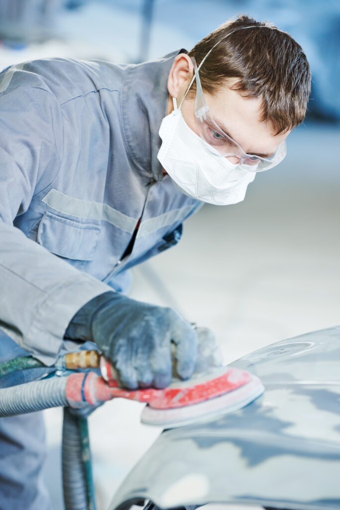 Mechanic Fixing Car Dent